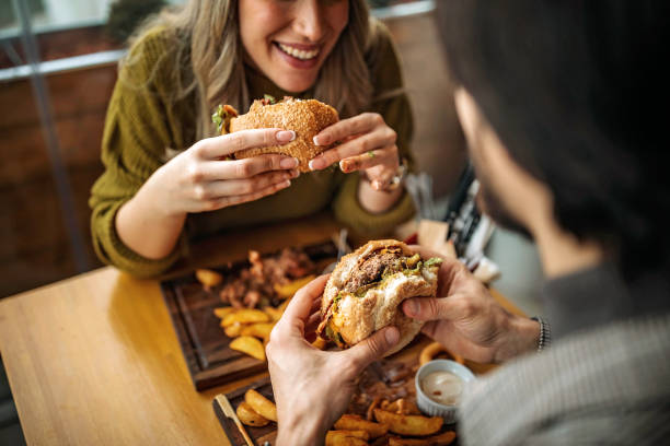 Hamburger for two People elating hamburger fast food restaurant stock pictures, royalty-free photos & images