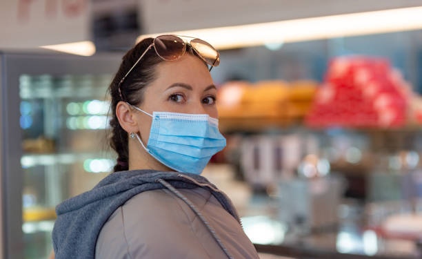 istock Young woman in protective mask inside cafe. covid 19 1293369586