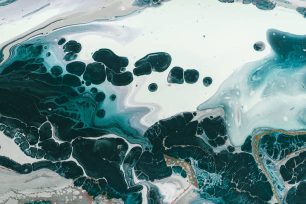 istock Fluid Art. Liquid dark green paint spreads in waves and bubbles. Marble effect background or texture 1293373275