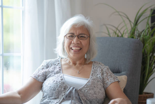 istock Senior Filipino female smiling at camera 1293373324