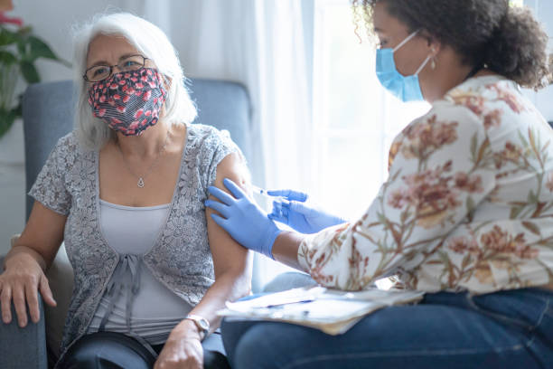 istock Senior Filipino patient wearing face mask getting vaccination 1293373338
