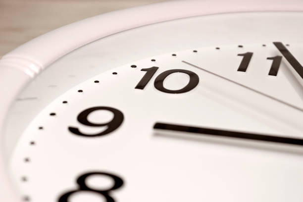 istock Dial of an analog Watch close up. Time 08:55. White dial, black numerals. 1293373503