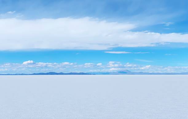 istock Desert white salt flat plain infinity eternity Salar de Uyuni unique vast terrain, white clouds in heaven over white mineral land Altiplano plateau. 1293374443