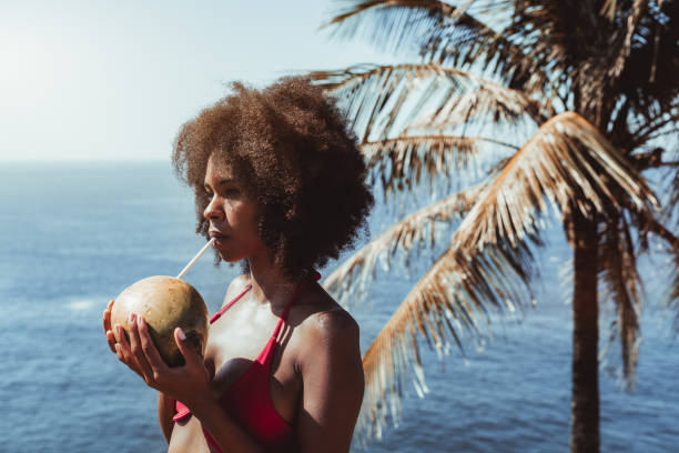 Girl drinking coconut water, resort