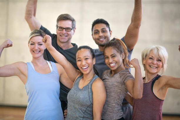 Beautiful smiling faces of a multi ethnic group of fitness enthusiasts. They are all wearing athletic clothing and smiling at the camera.