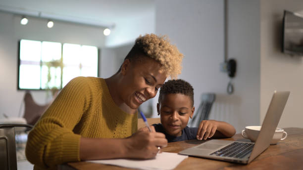 istock Mother helping son with home work at home 1293379565