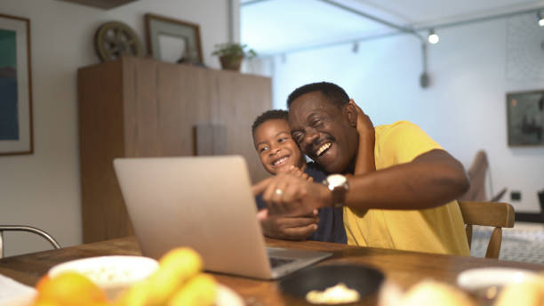 istock Father helping son studying at home 1293381279