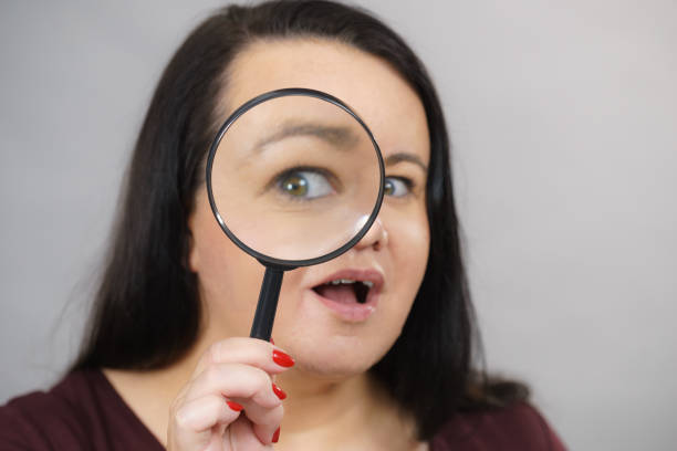 istock Adult woman with magnifying glss 1293387833