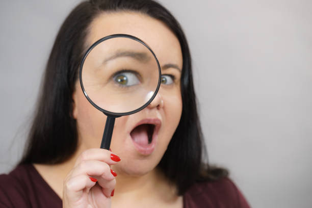 istock Adult woman with magnifying glss 1293387969