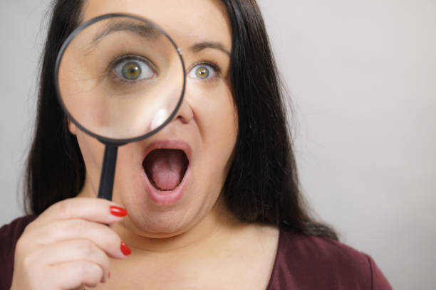 istock Adult woman with magnifying glss 1293388024