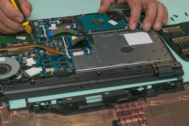 istock A man performs replacement of parts in a laptop. 1293388157
