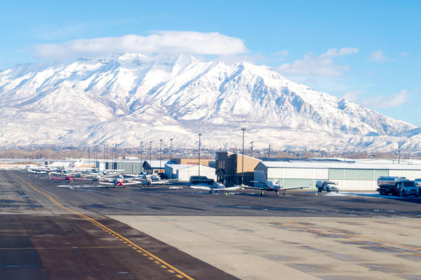 View from the Runway at the Provo Utah Airport December 19, 2020 - Provo, Utah, USA: This is the view from the runway of the airport in Provo, Utah.  This shot was taken from a passenger jet and shows a lineup of private planes and hangars.  In the distance is a snow covered Mt. Timpanogos. provo stock pictures, royalty-free photos & images
