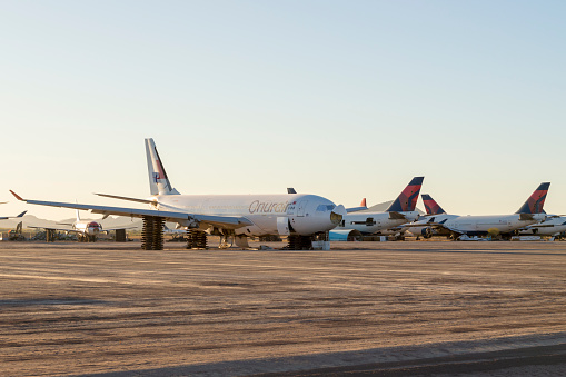 December 20, 2020 - Pinal County, Arizona, USA: This group of passenger jets is parked at the Pinal County Airport in Arizona.  These jets have been decommissioned and are slowly being scrapped for parts.  Engines and landing gear have already been removed from some of these planes and they are raised up on stacks of wooden pallets.