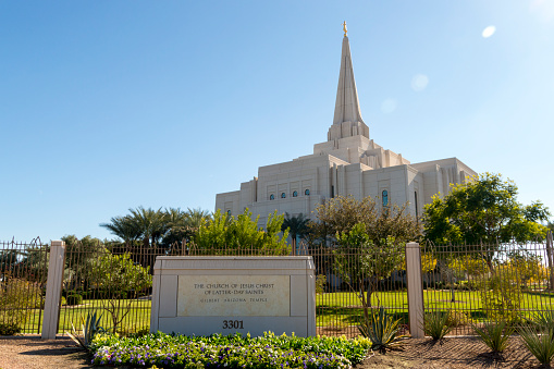 December 19, 2020 - Gilbert, Arizona, USA: This is a winter view of the exterior of the Gilbert Temple, operated by the Church of Jesus Christ of Latter-day Saints.  The grounds of the temple are decorated in blooming flowers and palm trees.