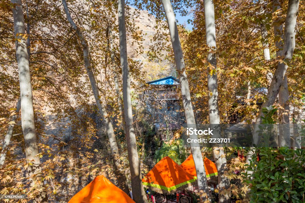 Iranian restaurants covered by golden leaves in entrance of Darband valley of the Tochal mountain. A popular recreational region for Tehran's residents Architecture Stock Photo