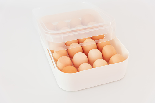 chicken eggs in a plastic container isolated on a white background