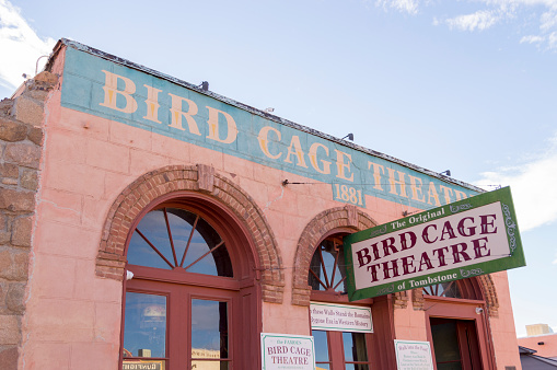 December 22, 2020 - Tombstone, Arizona, USA: This shot shows the famous Bird Cage Theatre in Tombstone, Arizona. This street out front has a dirt surface and is kept free from automobile traffic to preserve a taste of the old west.  This building saw many gunfights, shows, and poker matches.