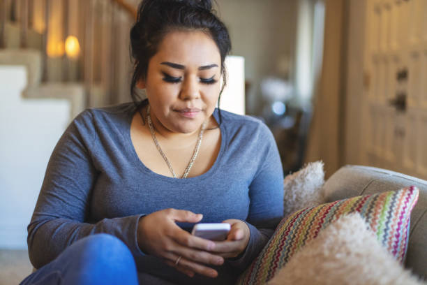 istock Generation Z Female of Native American Ethnicity Using Smart Phone 1293395377