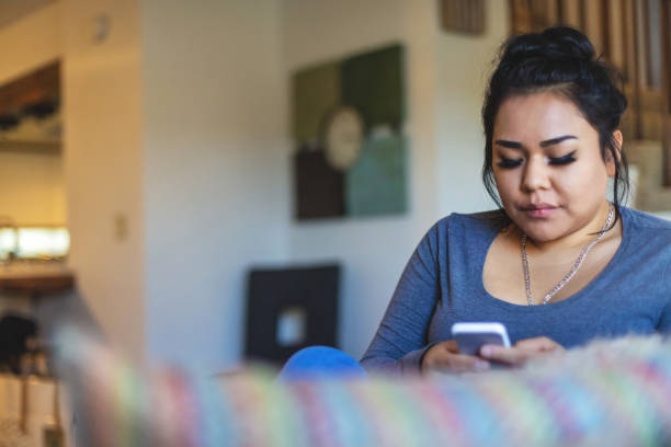 istock Generation Z Female of Native American Ethnicity Using Smart Phone 1293395421