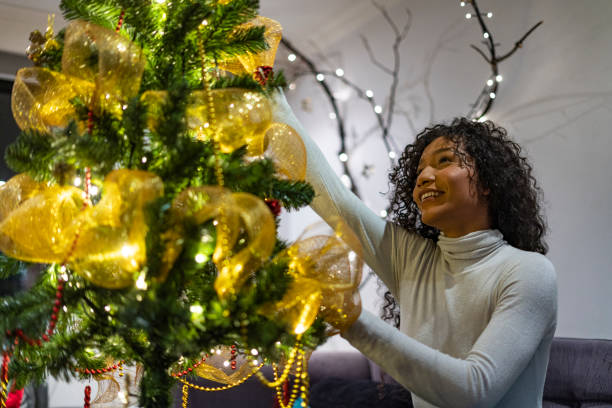 istock Woman is at home decorating the Christmas tree 1293398015