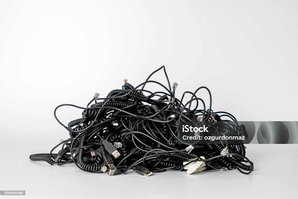 Heap of different computer cables and plugs with a moden digital tablet isolated on white background Cable Stock Photo