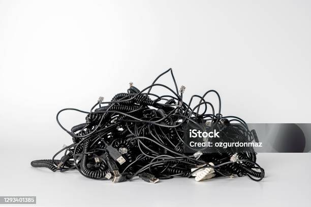 Heap Of Different Computer Cables And Plugs With A Moden Digital Tablet Isolated On White Background Stock Photo - Download Image Now