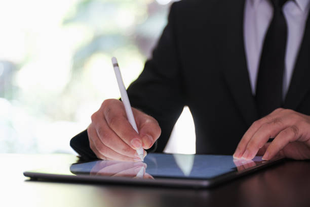 istock Businessman Signing Digital Contract On Tablet Using Stylus Pen 1293402037