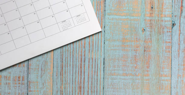 istock Calendar page on pastel blue color wood table background. Copy space. 1293404820