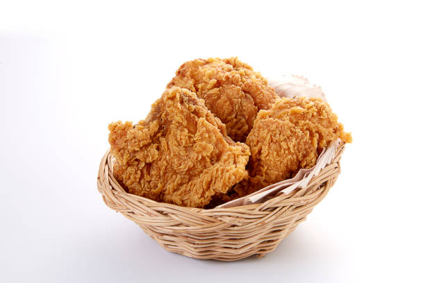 crispy fried chicken in basket on white table