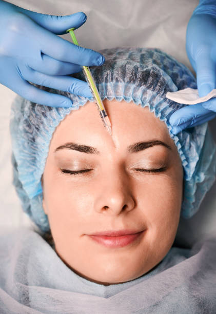 istock Female client getting beauty injection at wellness center. 1293406870