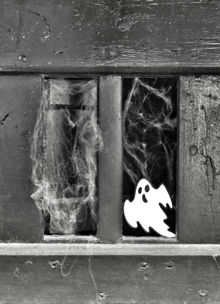 istock White ghost on old green door with cobwebs 1293407100