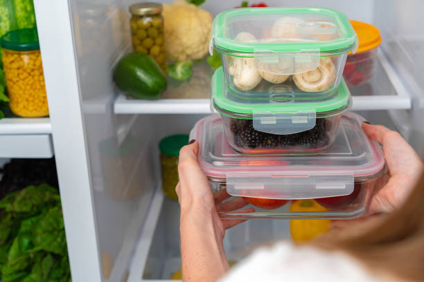 istock Female hands taking storage box with food from a fridge 1293407850