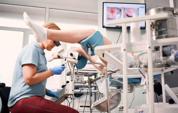 istock Doctor examining female patient with colposcope. 1293409504