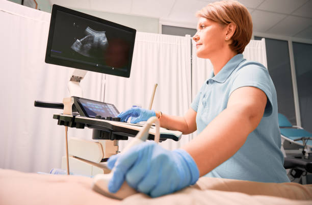 istock Doctor performing ultrasound procedure in modern clinic. 1293409554