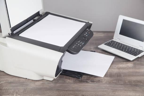 istock Xerox printer machine, laptop and papers on the desk. 1293410338