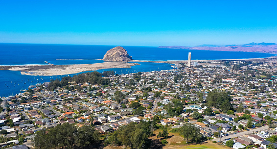 Aerial view, Morro Rock is a volcanic plug in Morro Bay, California, on the Pacific Coast at the entrance to Morro Bay harbor.
