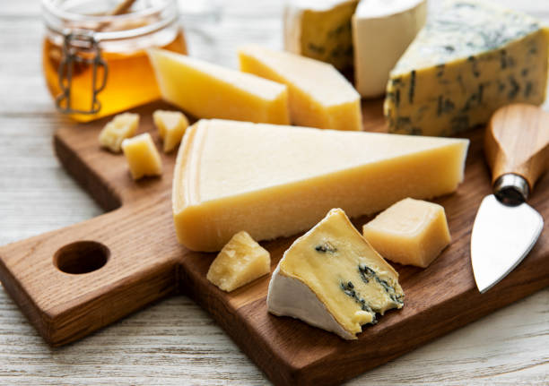 istock Various types of cheese  on a white wooden  background 1293411466