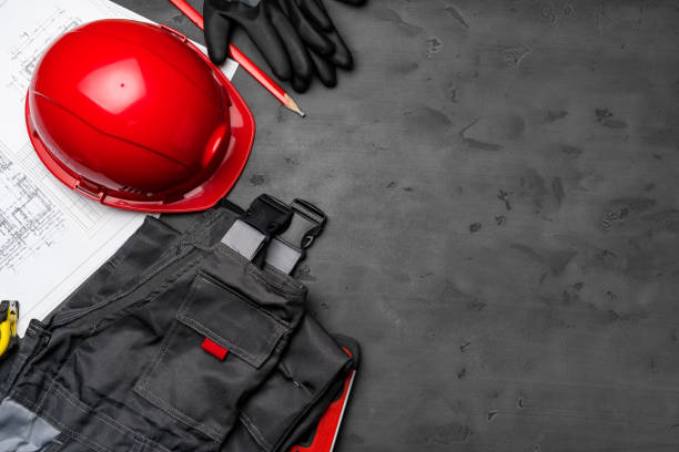 istock Construction worker unifrom, hardhat and blueprints on wooden background 1293412673