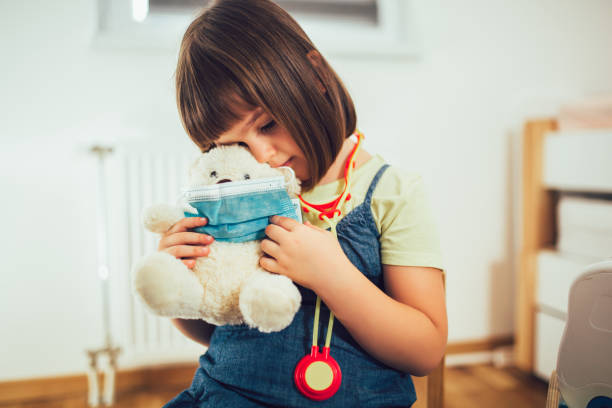 istock Child playing doctor with soft toy. 1293415352