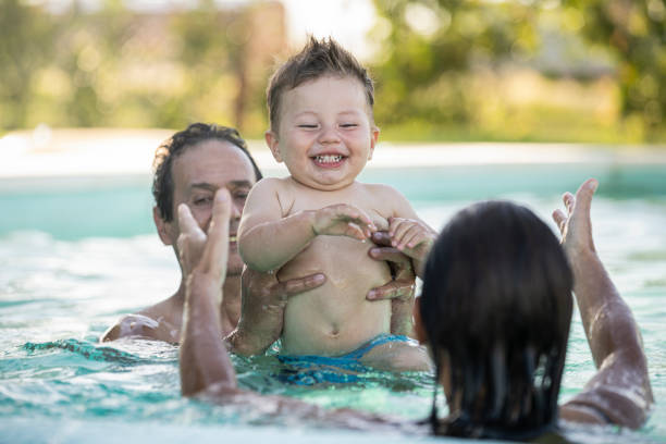 istock Family enjoying in swimming pool 1293417678