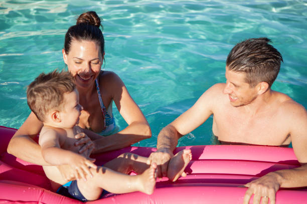 istock Family enjoying in swimming pool 1293417680