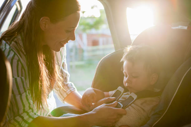 istock Mother fastening seat belt for his son 1293417865