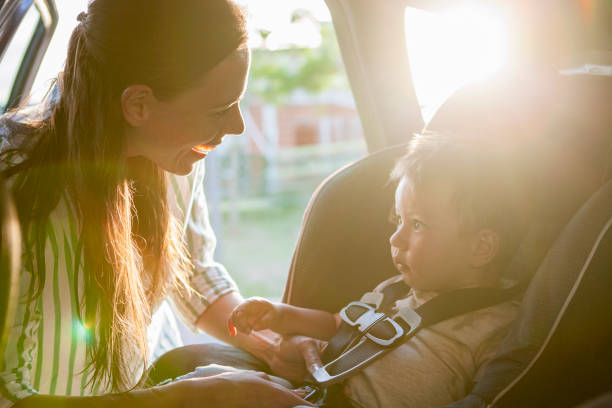 istock Mother fastening seat belt for his son 1293417873