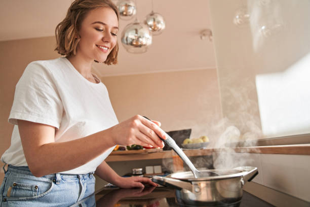 istock Woman holding cooking ladle spoon 1293417969