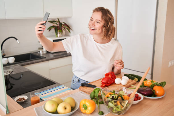 istock Girl taking a selfie while standing at the kitchen 1293417988