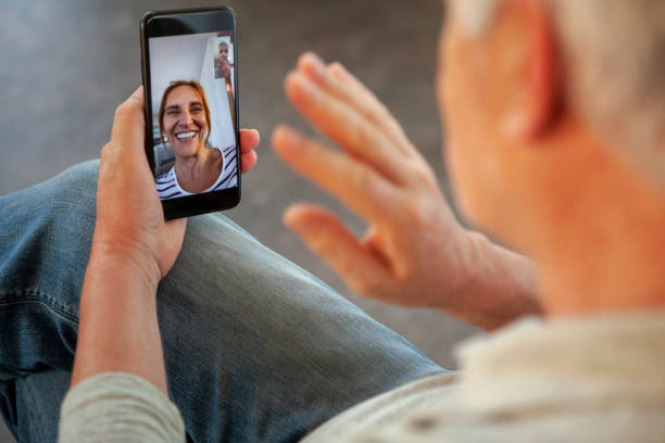 istock Husband talking with his wife on video call 1293418095