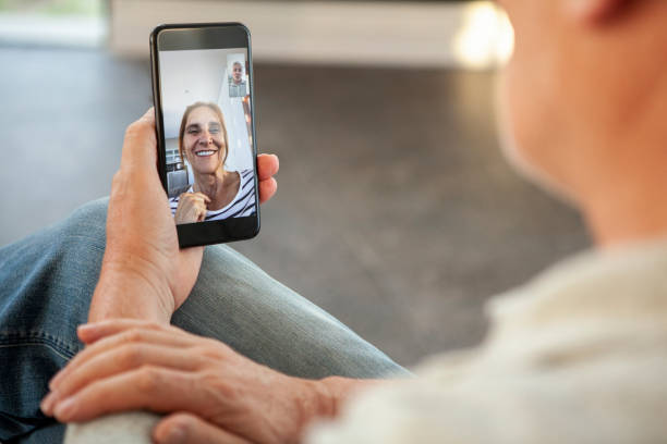 istock Husband talking with his wife on video call 1293418115