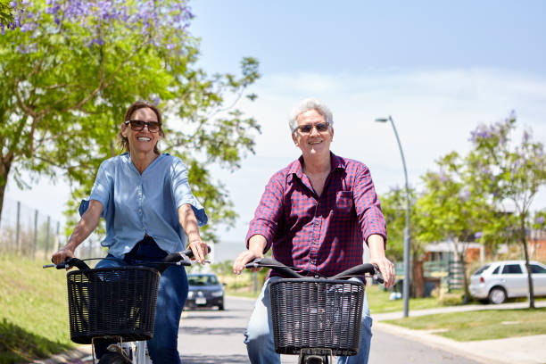 istock Couple cycling on street 1293418116