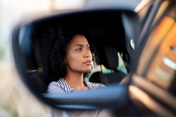 istock Young woman driving car 1293418371