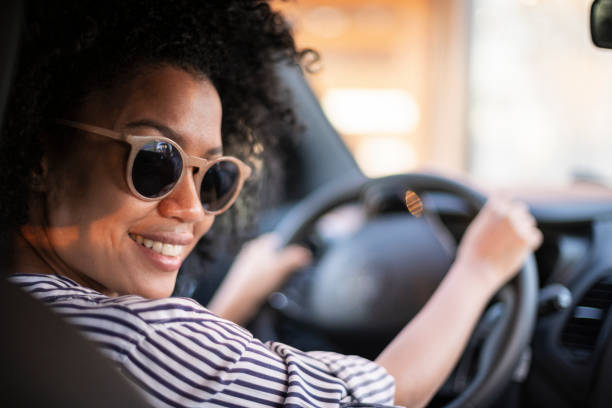 istock Young woman driving car 1293418373